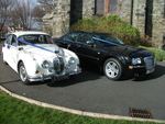 Jaguar Mark 2 in Old English White and Chrysler 300 Saloon in Black